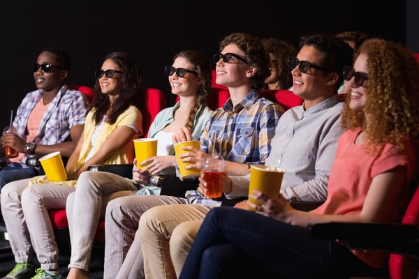 Young friends watching a 3d film at the cinema